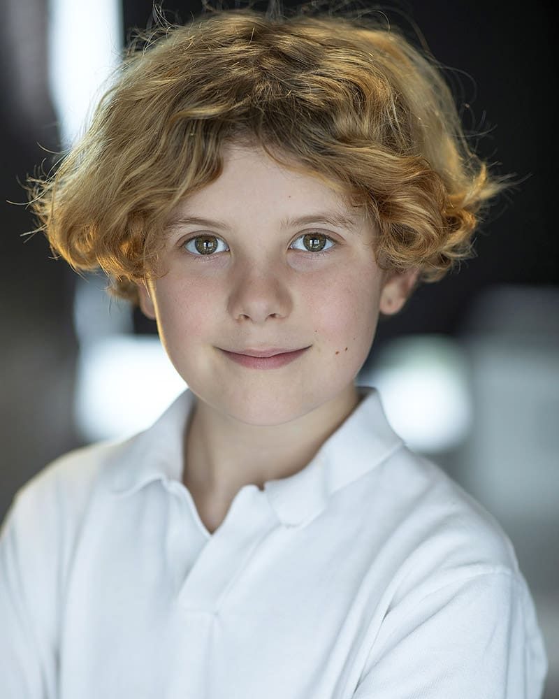 Smiley natural light headshot in the studio of actor Casper Prior