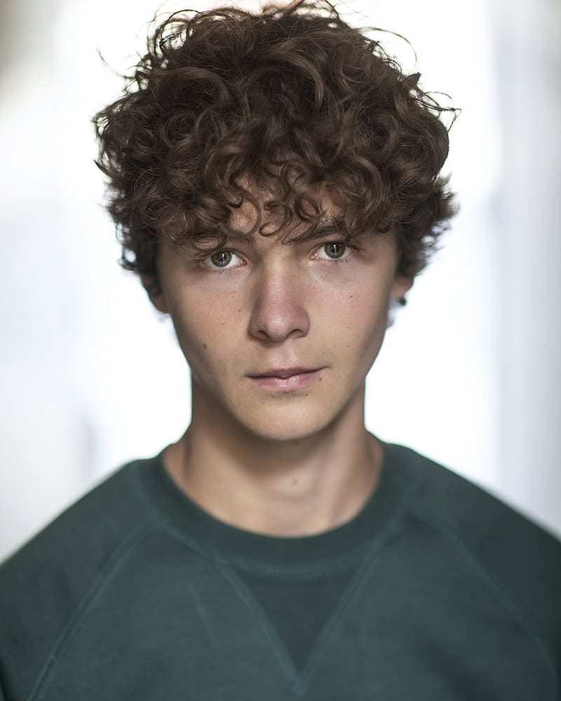 Serious outdoor headshot of actor Henry Wilton Hunt taken by London headshot photographer Remy Hunter