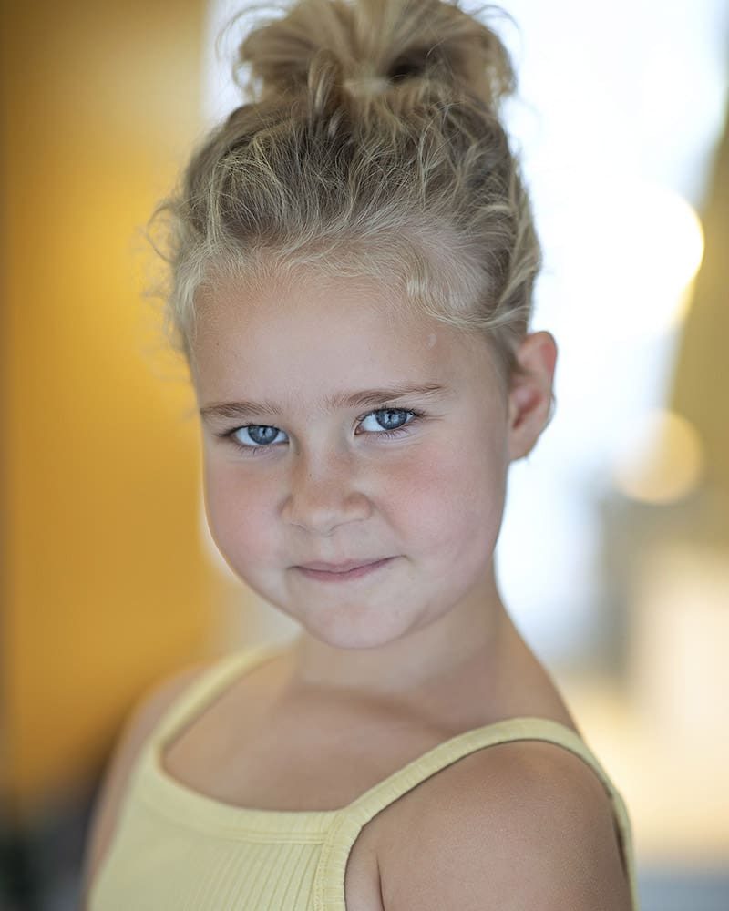 Smiley studio headshot of child actress Lettie-Mae Harkins taken by London headshot photographer Remy Hunter