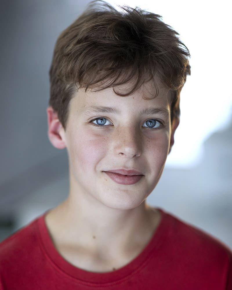 Smiley studio headshot of child actor Ted Giles taken by London headshot photographer Remy Hunter