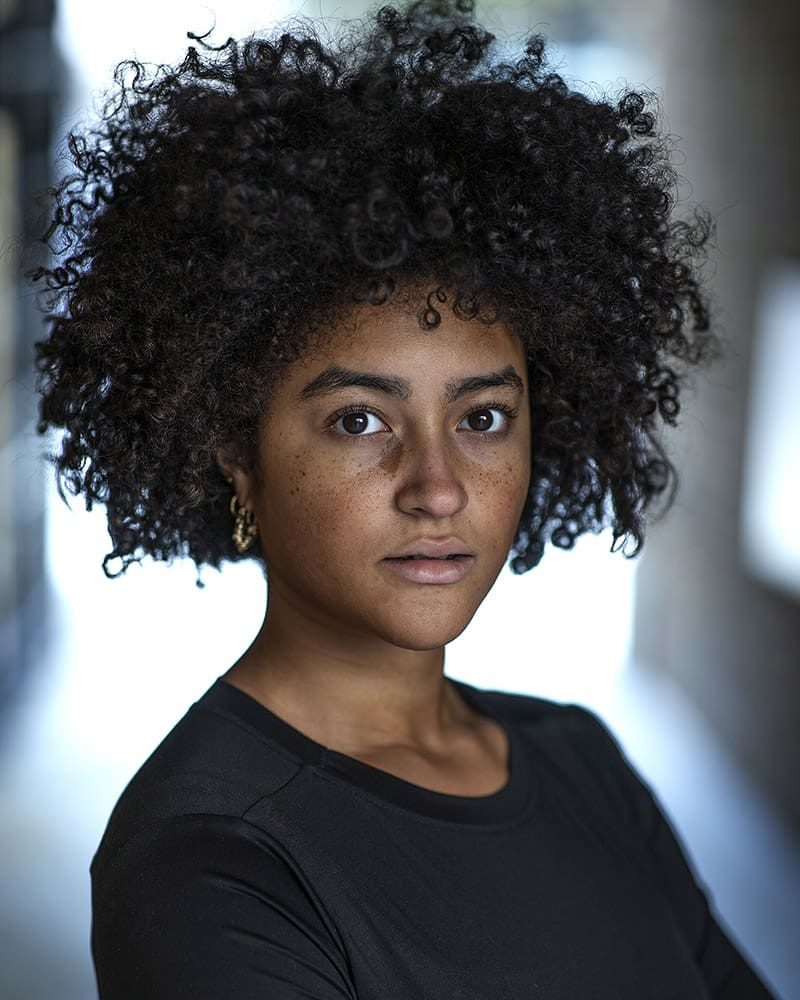 Serious outdoor headshot of actress Yasmine Bertrand taken by London headshot photographer Remy Hunter