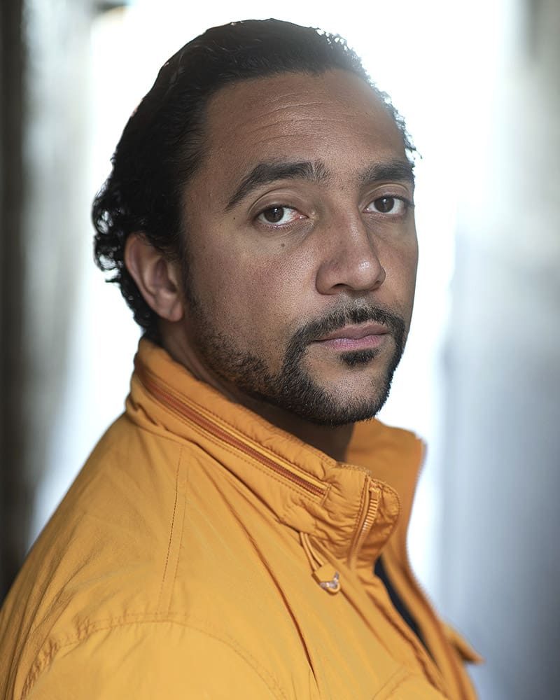 Serious outdoor professional headshot in natural light of actor Samuel Spring