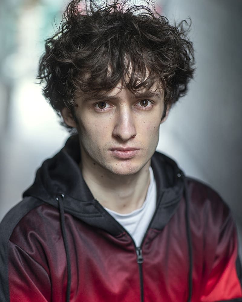 Serious outdoor headshot of actor Illirian Bushi taken by London headshot photographer Remy Hunter
