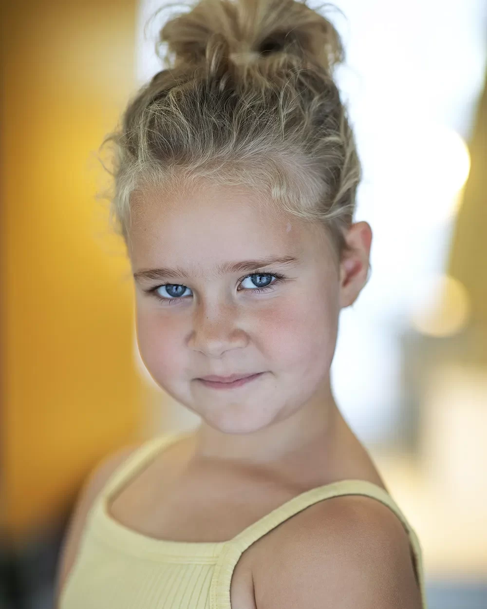 Smiley studio headshot of child actress Lettie-Mae Harkins taken by London headshot photographer Remy Hunter