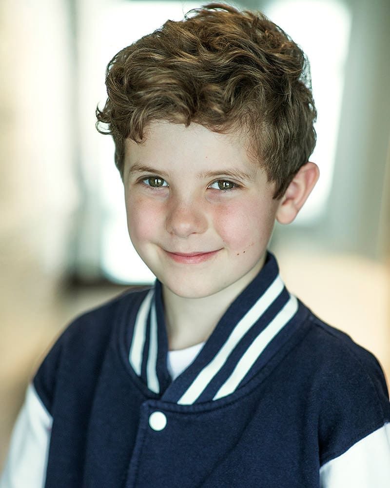 Smiley natural light headshot of child actor Casper Prior taken by London headshot photographer Remy Hunter