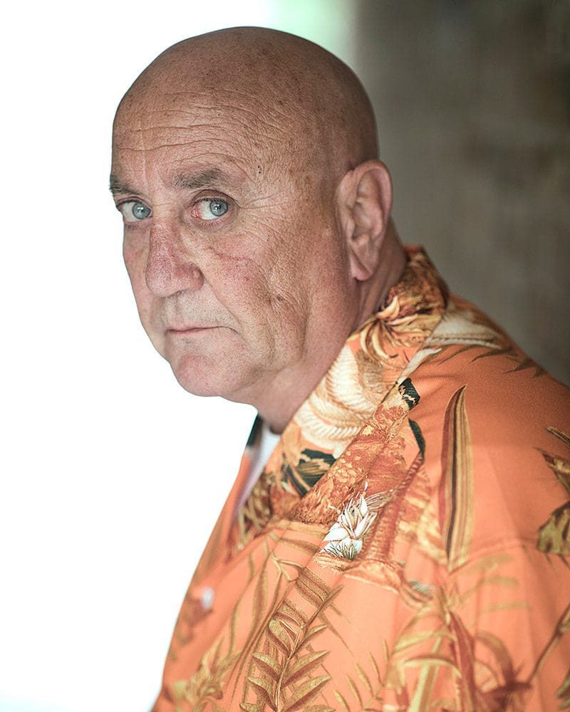 Professional actors headshot of actor Joe Cairo wearing an orange Hawaiian shirt